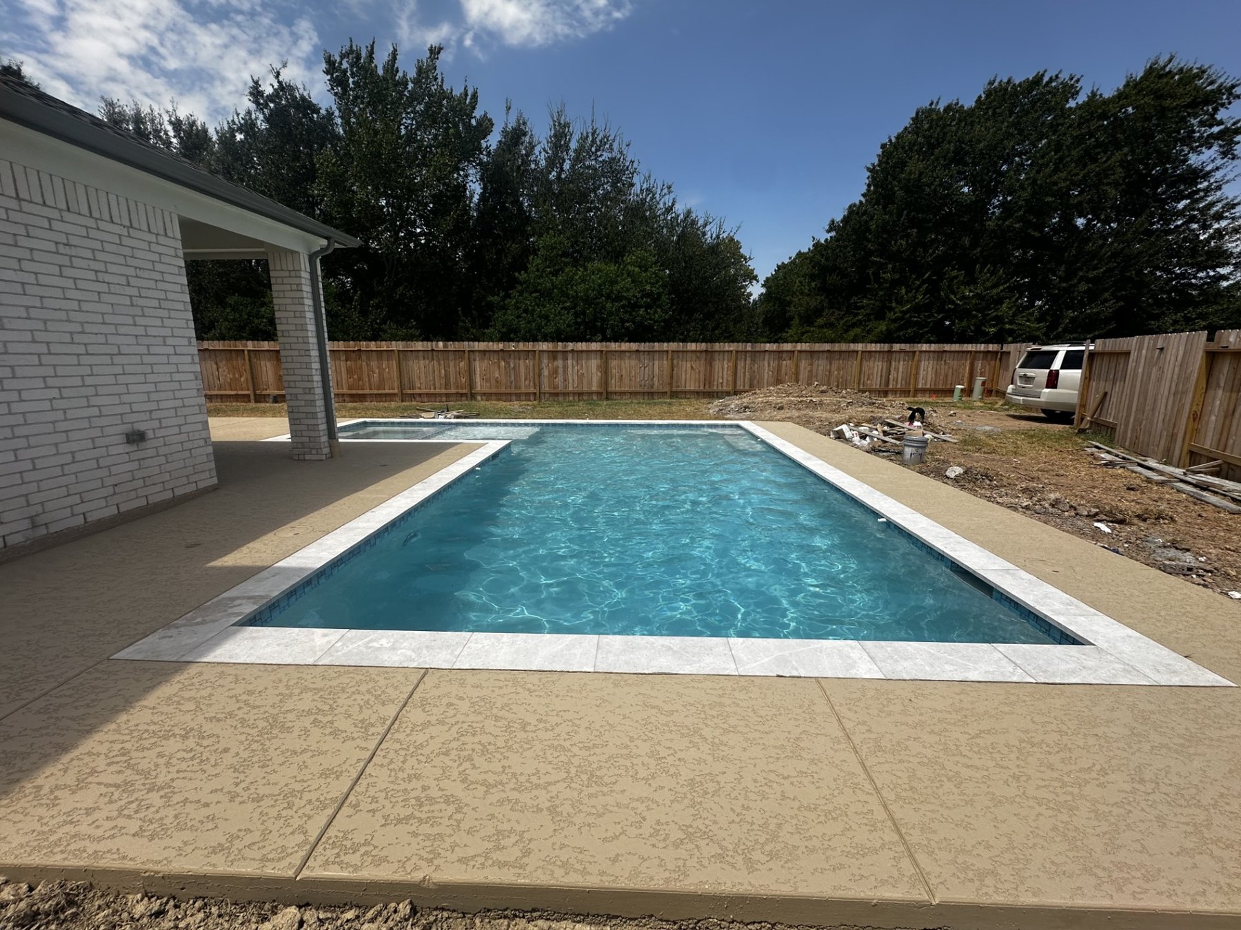 Rectangular swimming pool with raised spa viewed from the end